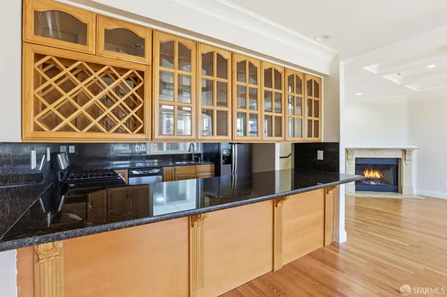 a kitchen with stainless steel appliances granite countertop a refrigerator and a stove