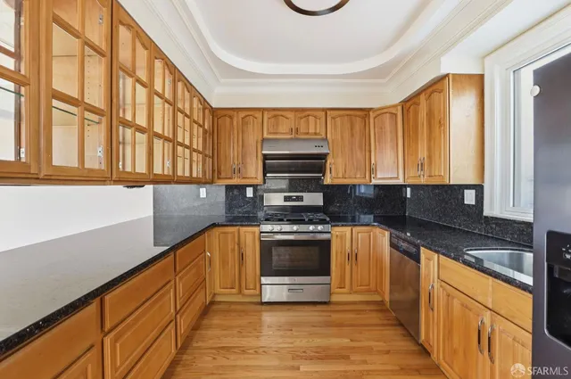 a view of a kitchen with a sink and wooden floor