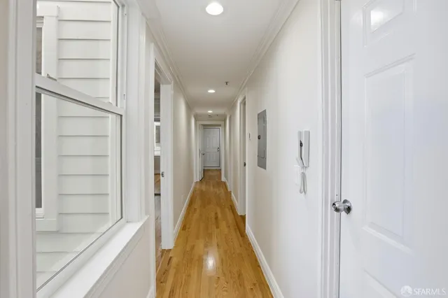 a bedroom with a large bed and a potted plant