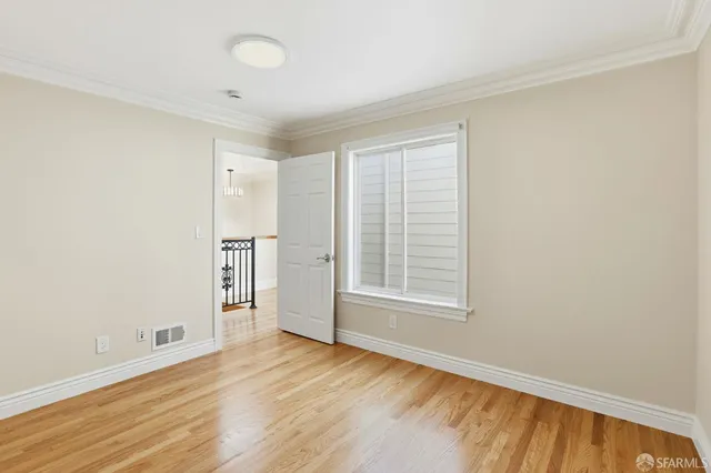 a bedroom with a bed and a potted plant