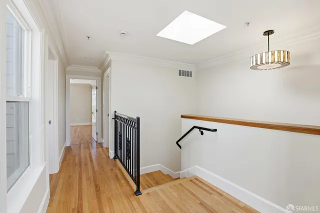 a view of a house with a large windows and flower plants