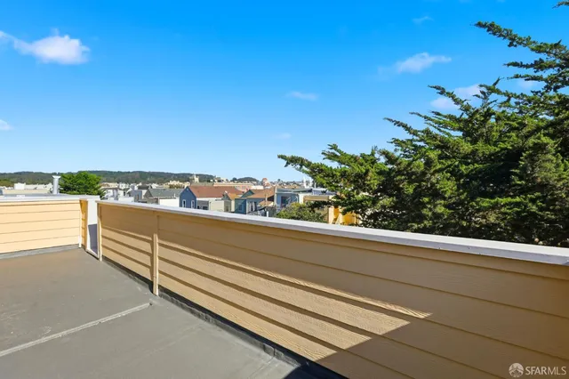 a view of a terrace with a table and chairs