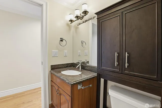 an empty room with wooden floor and window