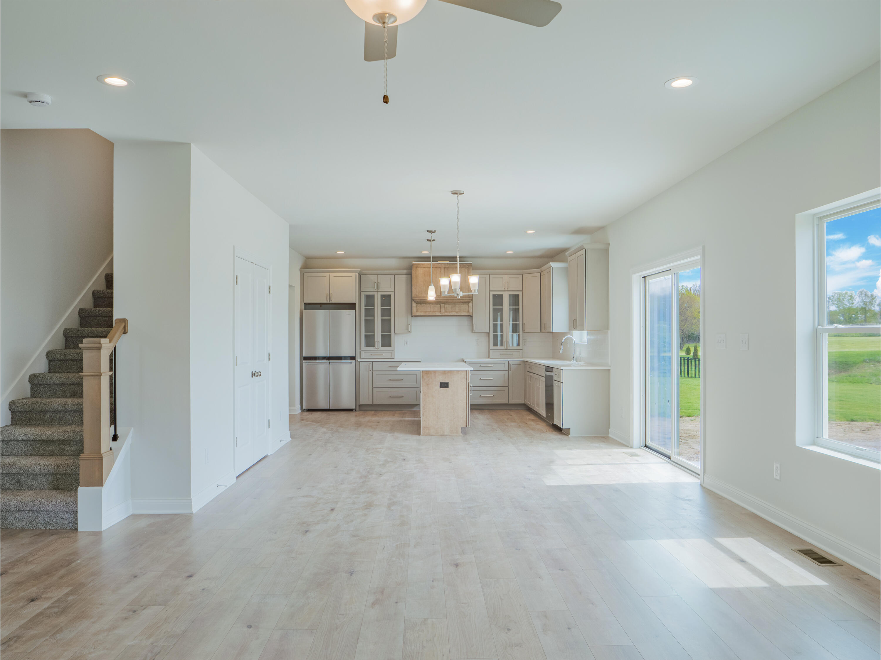 11659 Park Street Crown Point, IN 46307 - Photo 5 of 24 an empty room with a kitchen and windows