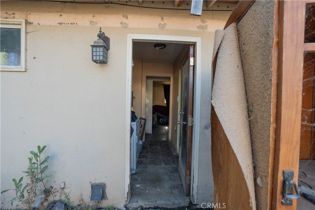 6174 Jurupa Avenue Riverside, CA 92504 - Photo 12 of 30 a view of a hallway with wooden floor and a potted plant