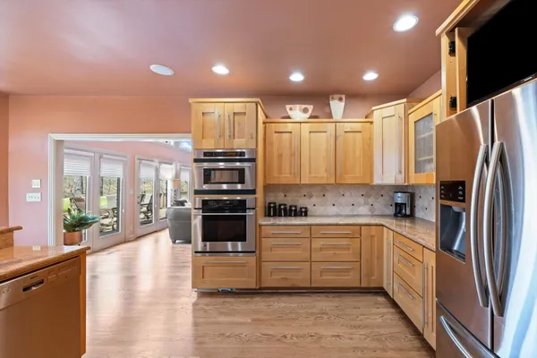 a kitchen with stainless steel appliances a refrigerator sink and microwave