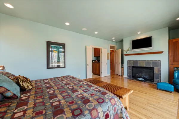 a bedroom with a bed and a fireplace