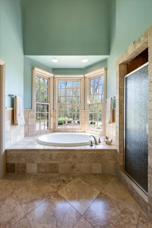 a view of bathroom with bathtub and shower