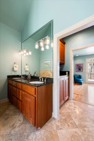 a large bathroom with a sink and large mirror