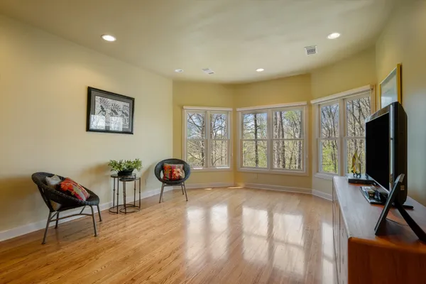 a living room with furniture a flat screen tv and a large window
