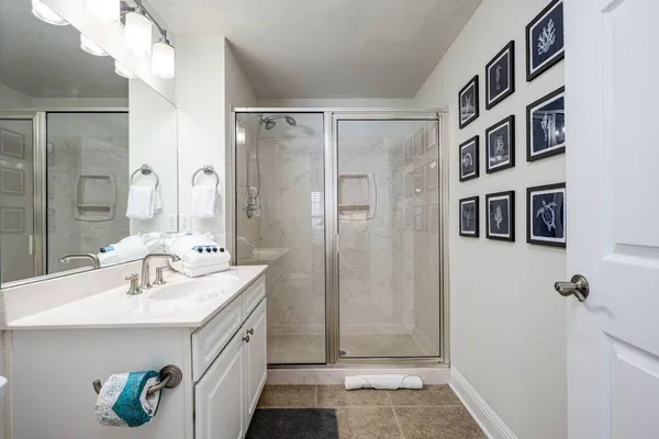 a bathroom with a sink a mirror and a shower