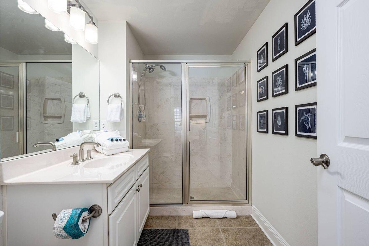 124 Village Boulevard, Unit 813 Santa Rosa Beach, FL 32459 - Photo 11 of 19 a bathroom with a sink a mirror and a shower