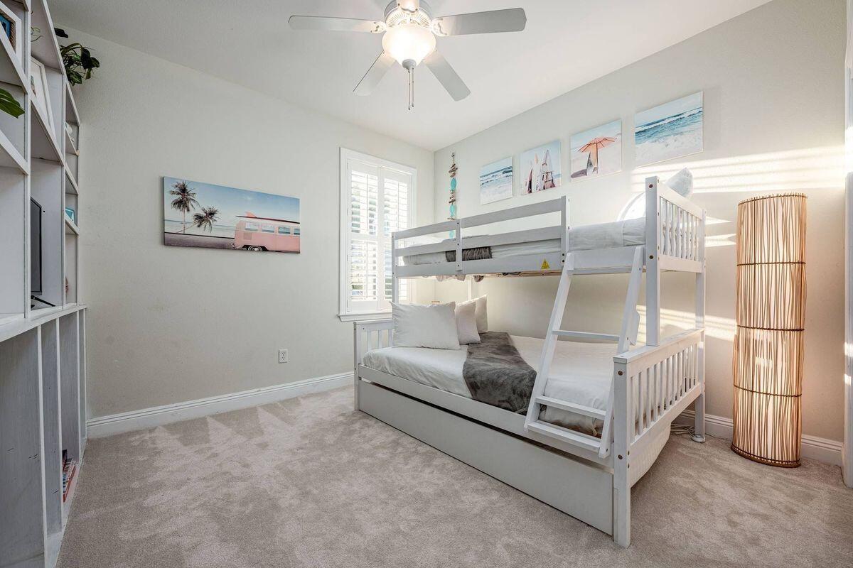 124 Village Boulevard, Unit 813 Santa Rosa Beach, FL 32459 - Photo 12 of 19 a bed room with a bed and a chandelier