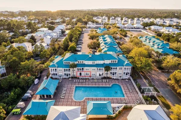 an aerial view of house with yard space and ocean view