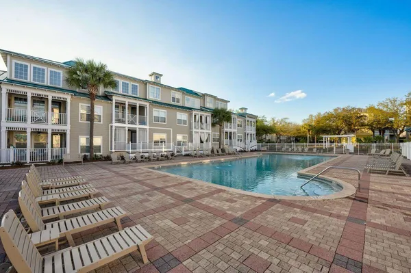 a view of a house with swimming pool and sitting area