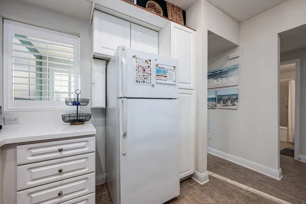 a kitchen with a refrigerator and countertop