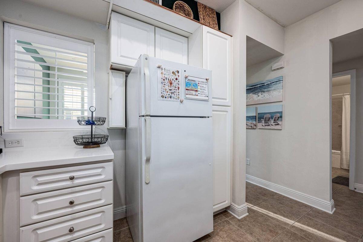 124 Village Boulevard, Unit 813 Santa Rosa Beach, FL 32459 - Photo 7 of 19 a kitchen with a refrigerator and countertop