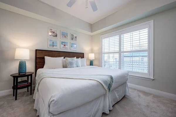 a bedroom with a bed and a night stand