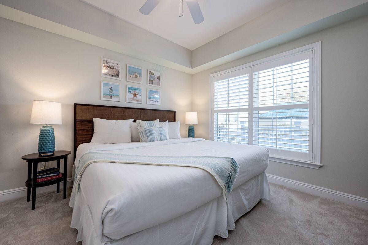 124 Village Boulevard, Unit 813 Santa Rosa Beach, FL 32459 - Photo 9 of 19 a bedroom with a bed and a night stand