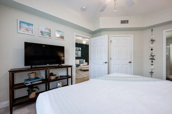 a bedroom with a bed and a flat screen tv