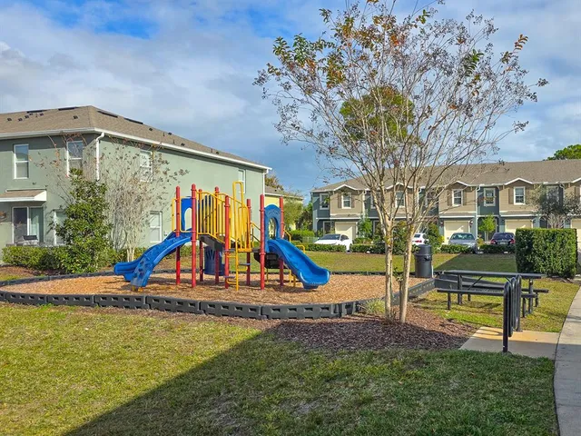 a view of park with swings and slides
