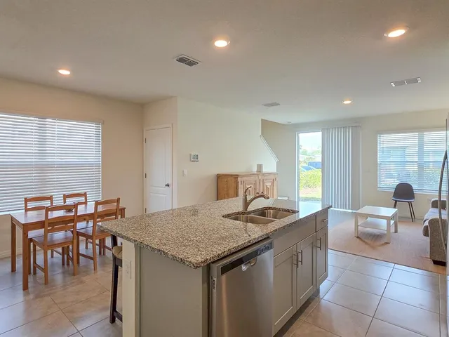a kitchen that has a table and chairs in it
