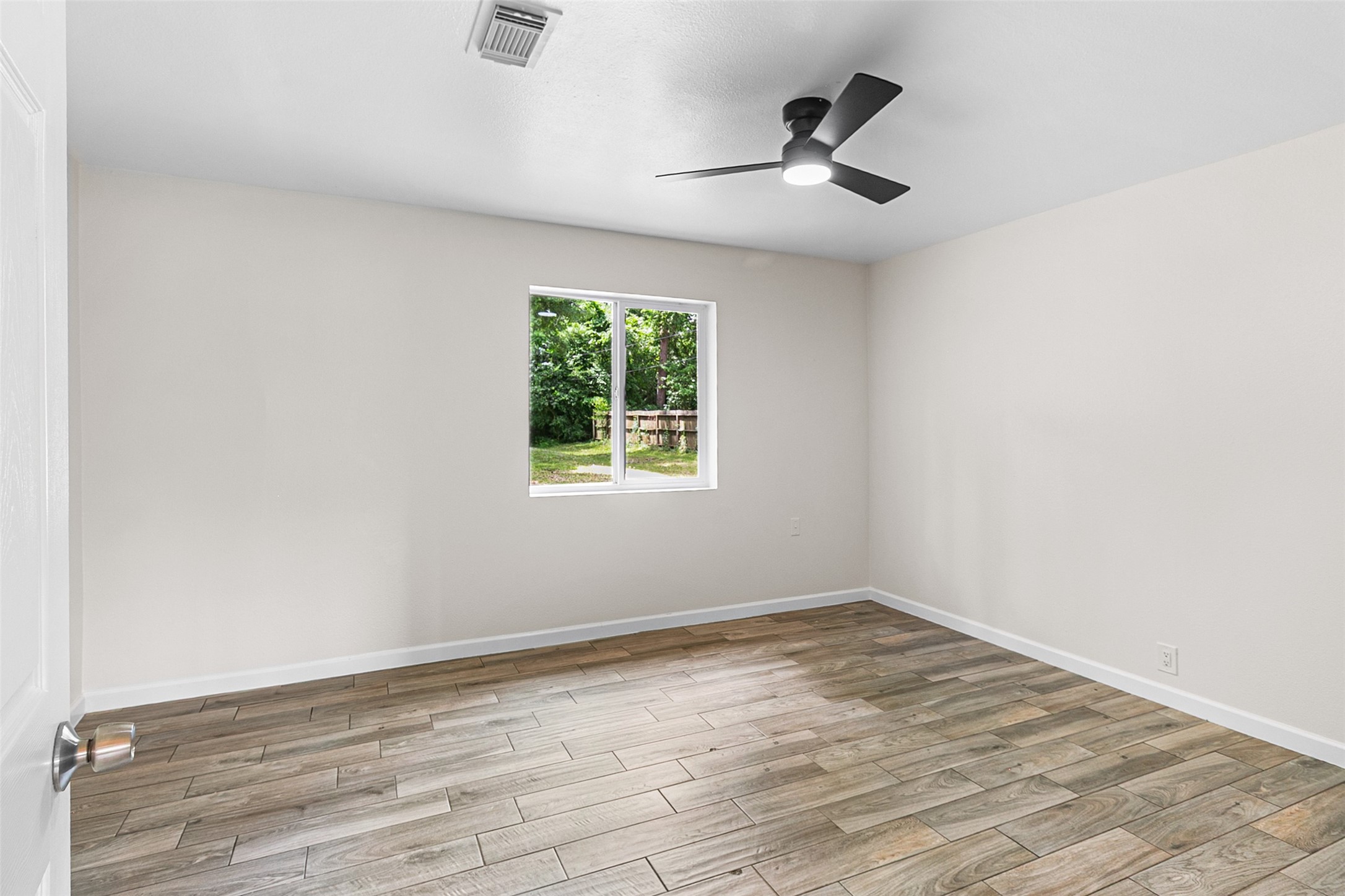 16715 Waycreek Road Houston, TX 77068 - Photo 20 of 41 an empty room with wooden floor and ceiling fan