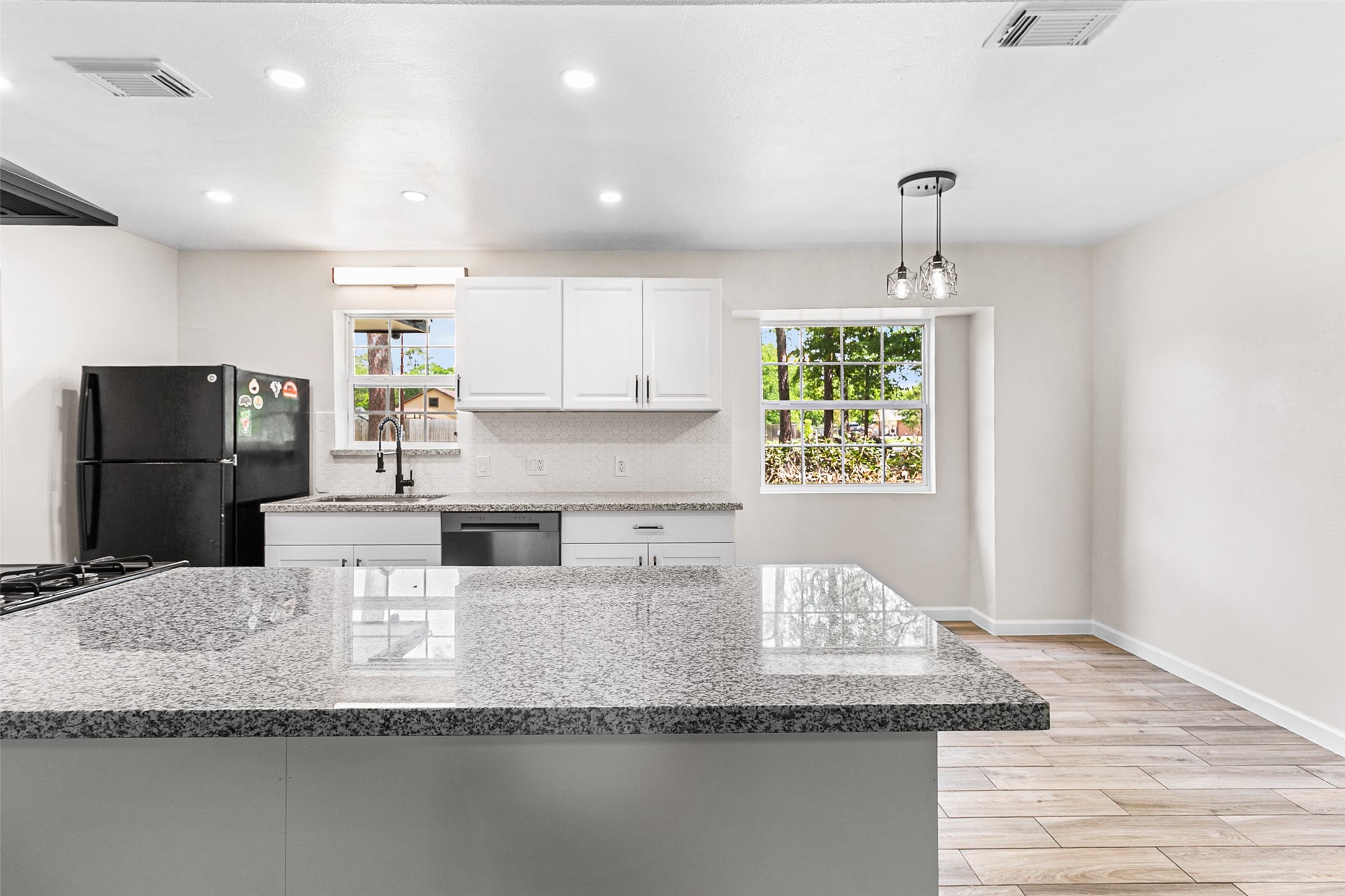 16715 Waycreek Road Houston, TX 77068 - Photo 5 of 41 a kitchen with kitchen island granite countertop a sink and a refrigerator