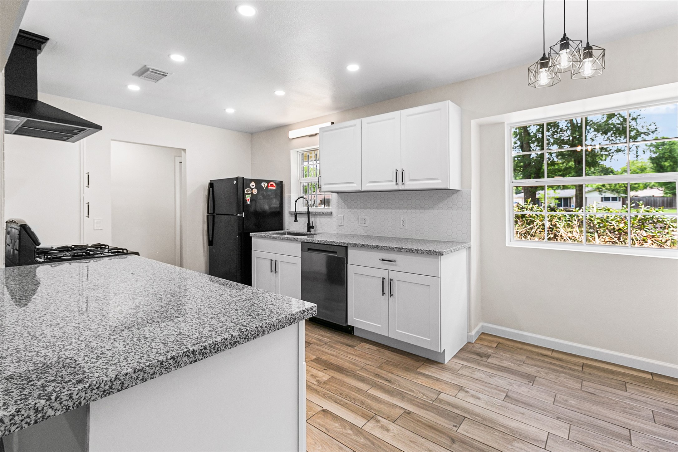 16715 Waycreek Road Houston, TX 77068 - Photo 7 of 41 a kitchen with a sink window and refrigerator