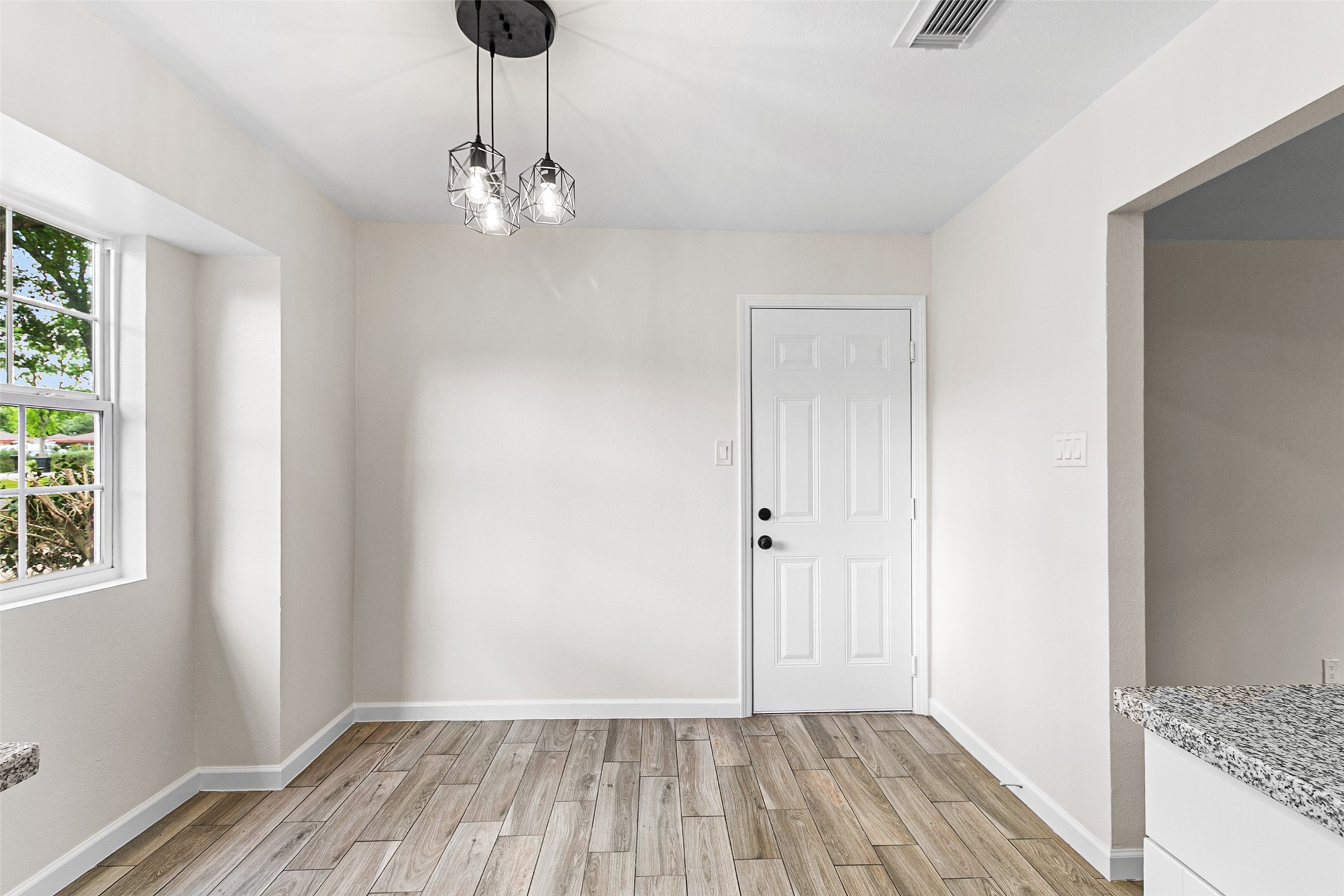 16715 Waycreek Road Houston, TX 77068 - Photo 9 of 41 a view of a room with wooden floor and chandelier