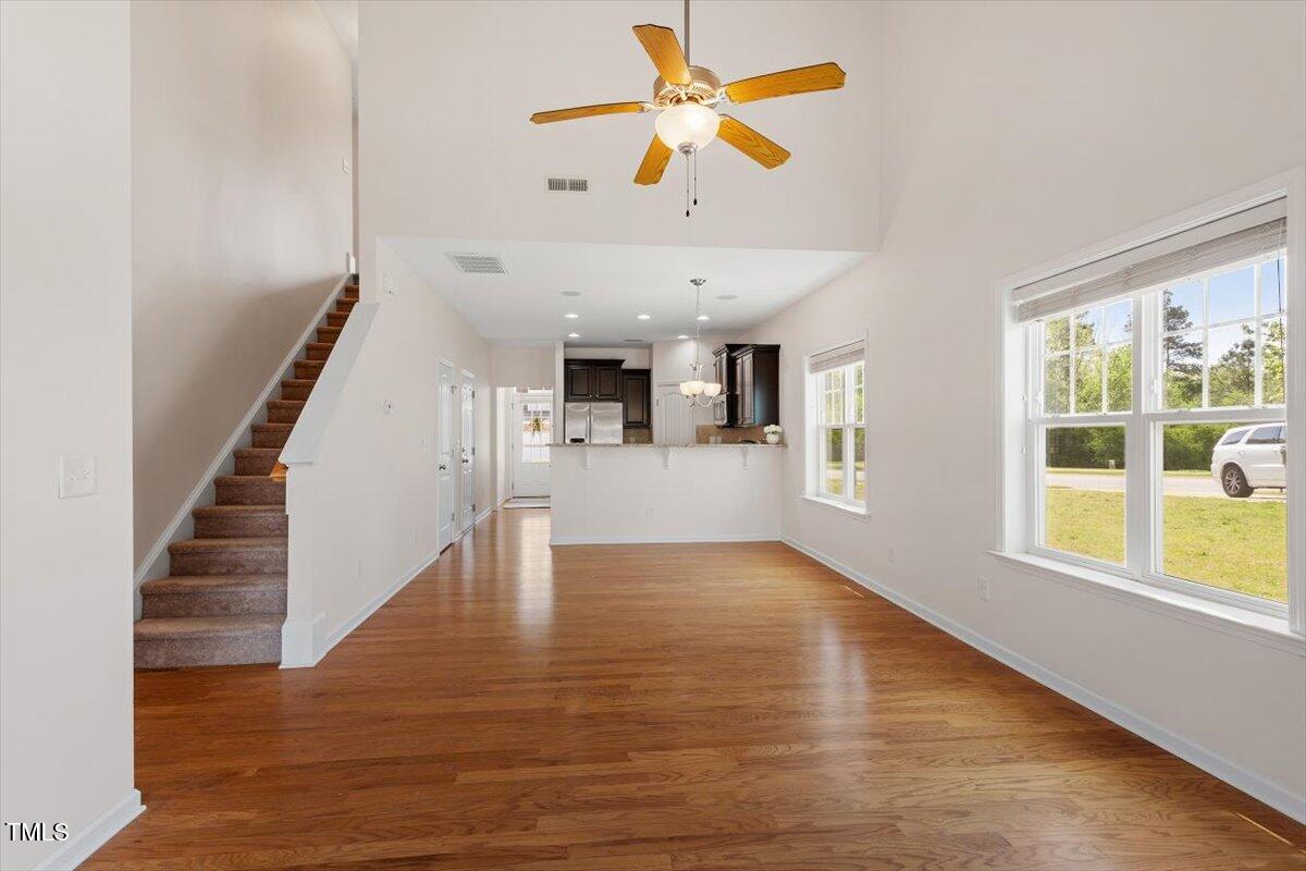 632 Hunters Ridge Drive Fuquay-Varina, NC 27526 - Photo 18 of 28 a view of an empty room with wooden floor and a window