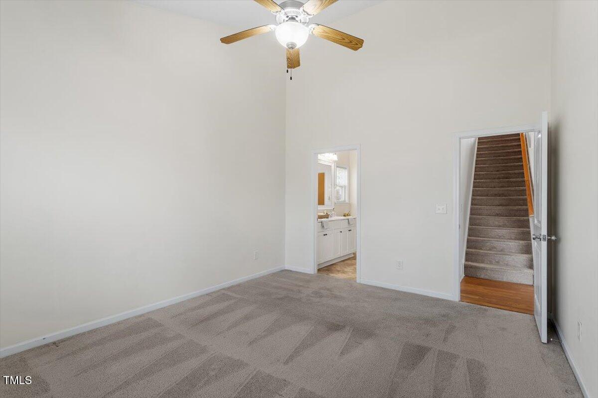 632 Hunters Ridge Drive Fuquay-Varina, NC 27526 - Photo 20 of 28 a view of an empty room with a ceiling fan