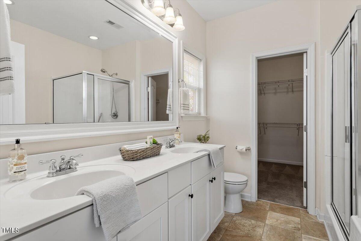 632 Hunters Ridge Drive Fuquay-Varina, NC 27526 - Photo 22 of 28 a bathroom with a double vanity sink mirror and toilet