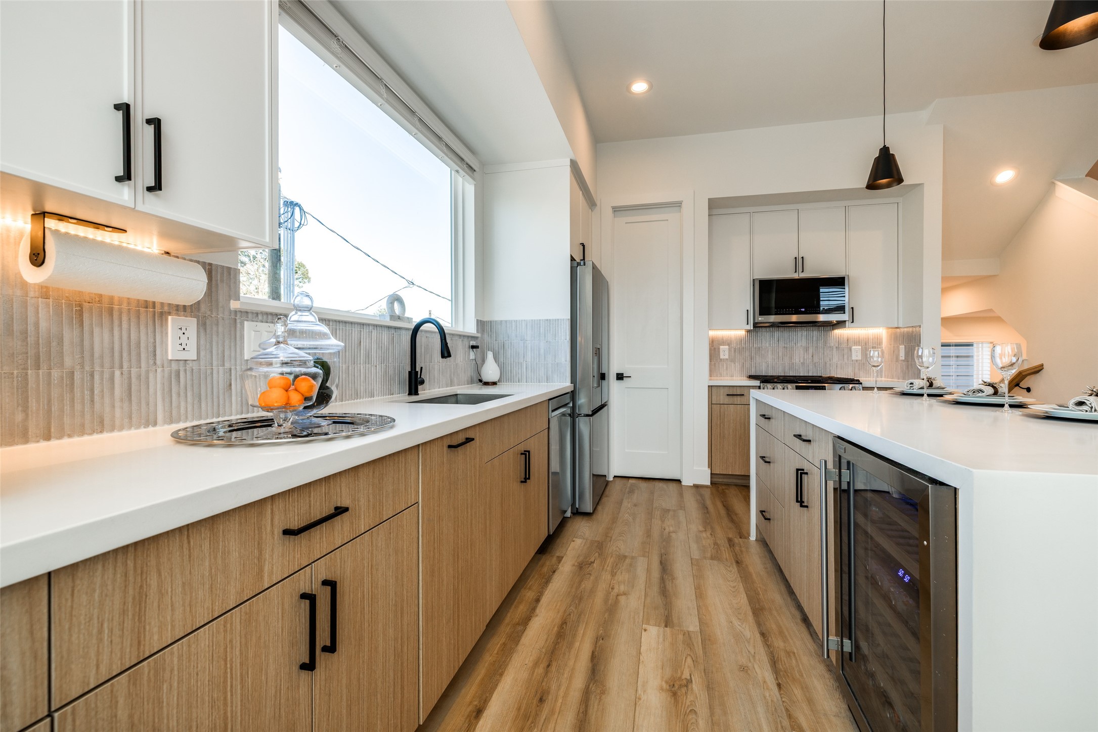 412 North Nagle Street Houston, TX 77003 - Photo 14 of 40 a kitchen with a sink a counter top space stainless steel appliances and a window