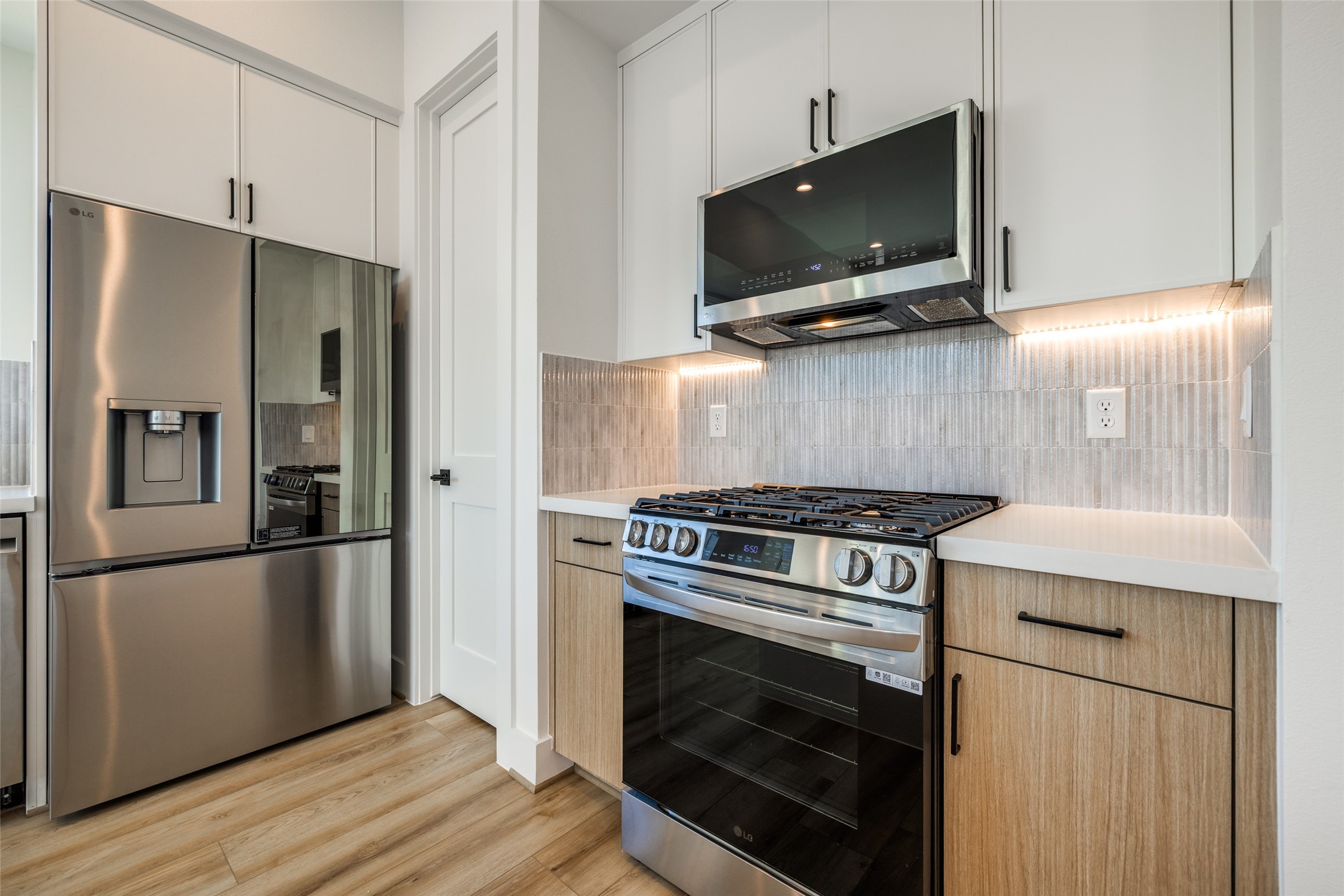 412 North Nagle Street Houston, TX 77003 - Photo 17 of 40 a kitchen with a stove and a microwave