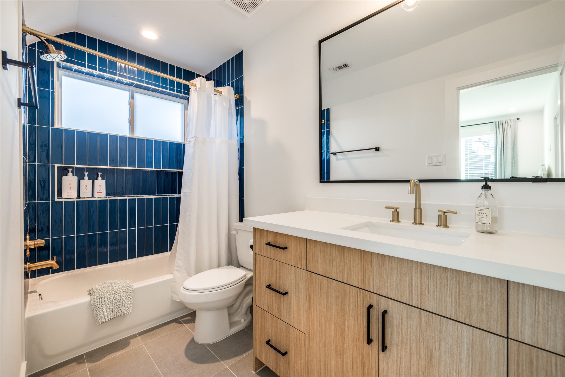 412 North Nagle Street Houston, TX 77003 - Photo 7 of 40 a bathroom with a sink a toilet a mirror and shower