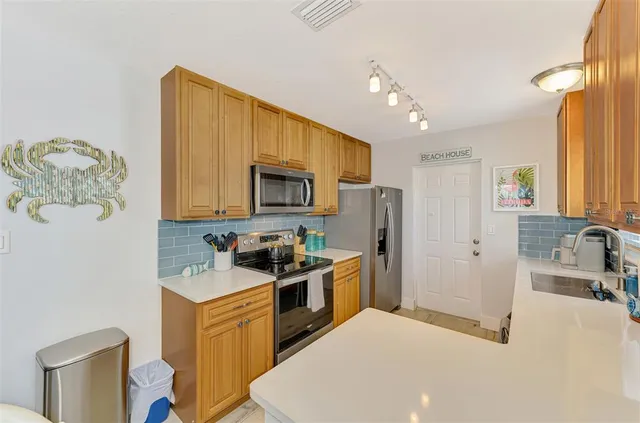 a kitchen with a sink a counter and cabinets