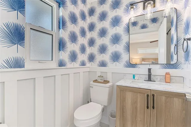 a bedroom with two beds and a flat screen tv