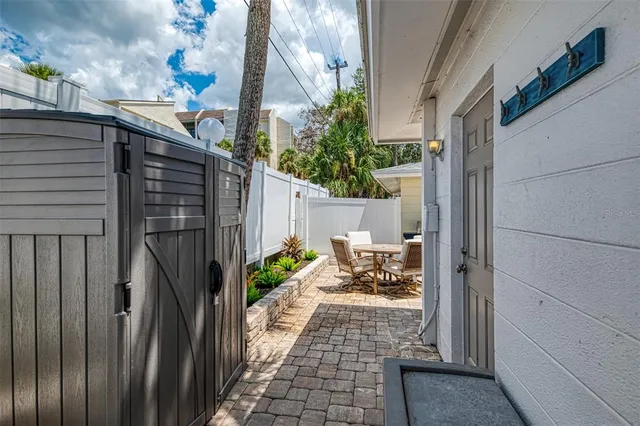 a view of a patio with table and chairs and potted plants