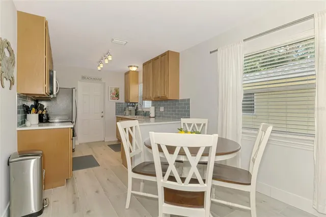 a view of a dining room with furniture and a window