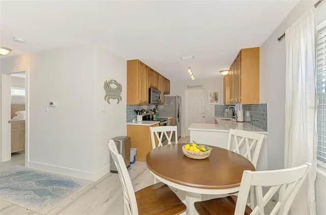 a kitchen with stainless steel appliances a sink a stove and a refrigerator