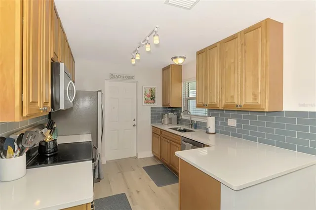 a kitchen that has a sink and a stove