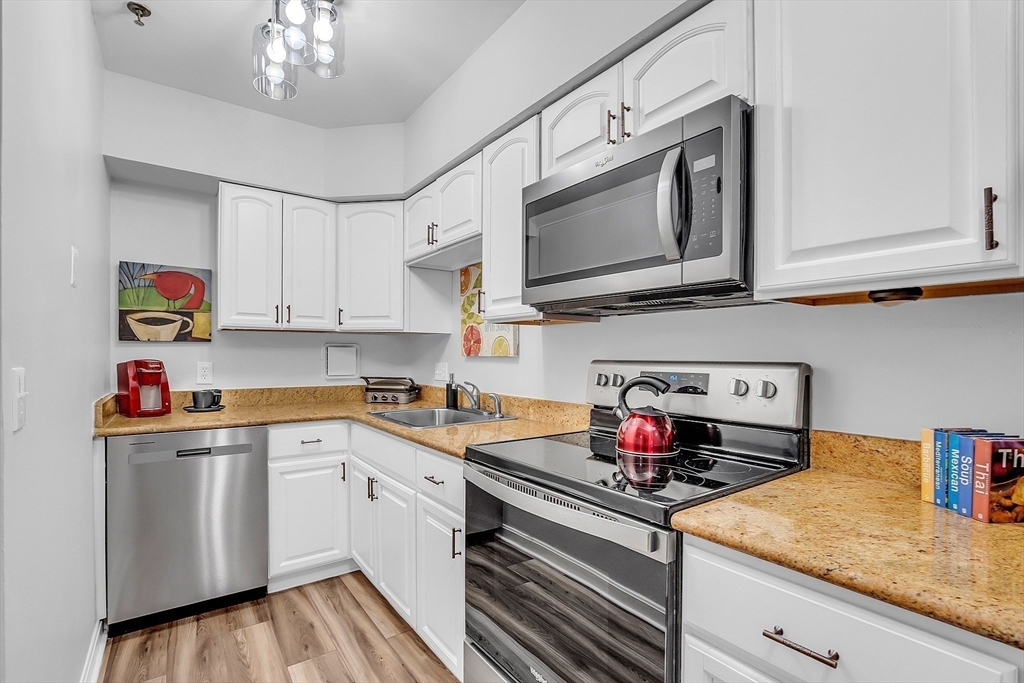 a kitchen with stainless steel appliances granite countertop a sink and cabinets