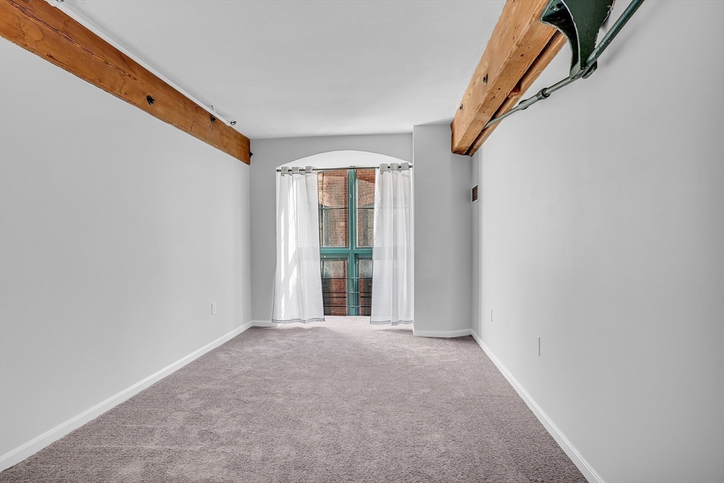 200 Market Street, Unit 117 Lowell, MA 01852 - Photo 20 of 37 a view of an empty room with a window
