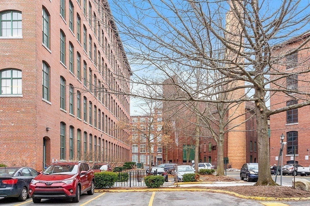 200 Market Street, Unit 117 Lowell, MA 01852 - Photo 33 of 37 a city street lined with buildings and cars