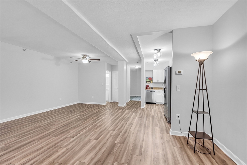 200 Market Street, Unit 117 Lowell, MA 01852 - Photo 6 of 37 wooden floor in an empty room with a window