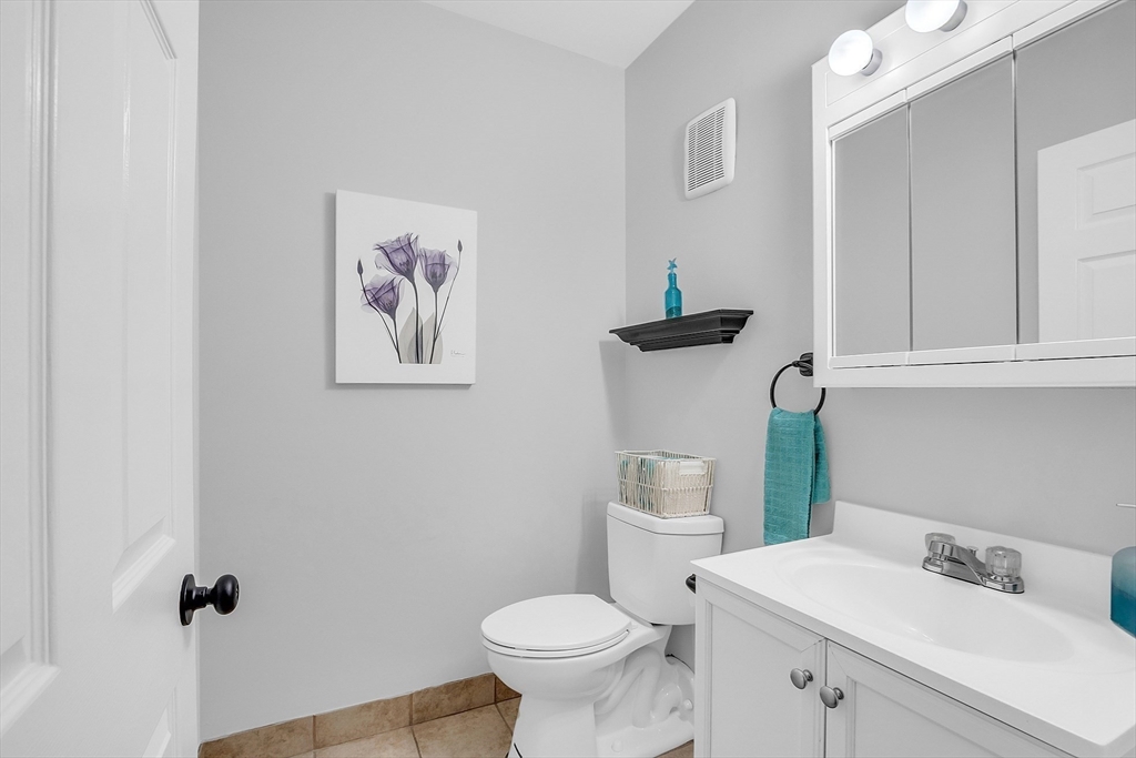 200 Market Street, Unit 117 Lowell, MA 01852 - Photo 9 of 37 a bathroom with a toilet sink and mirror