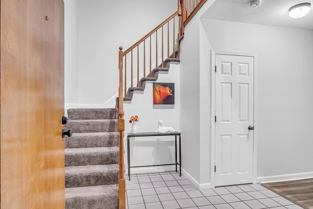 200 Market Street, Unit 117 Lowell, MA 01852 - Photo 10 of 37 a view of a hallway with stairs and wooden floor