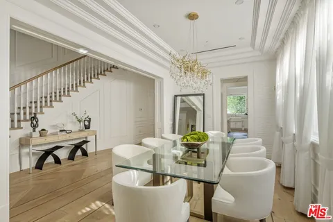 a view of a dining room with furniture and a chandelier