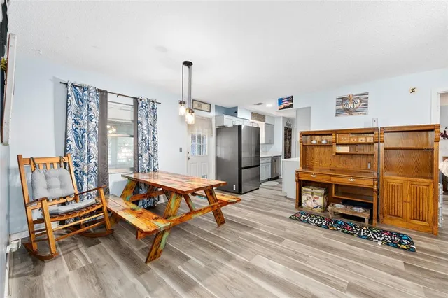 a living room with furniture a flat screen tv and a table